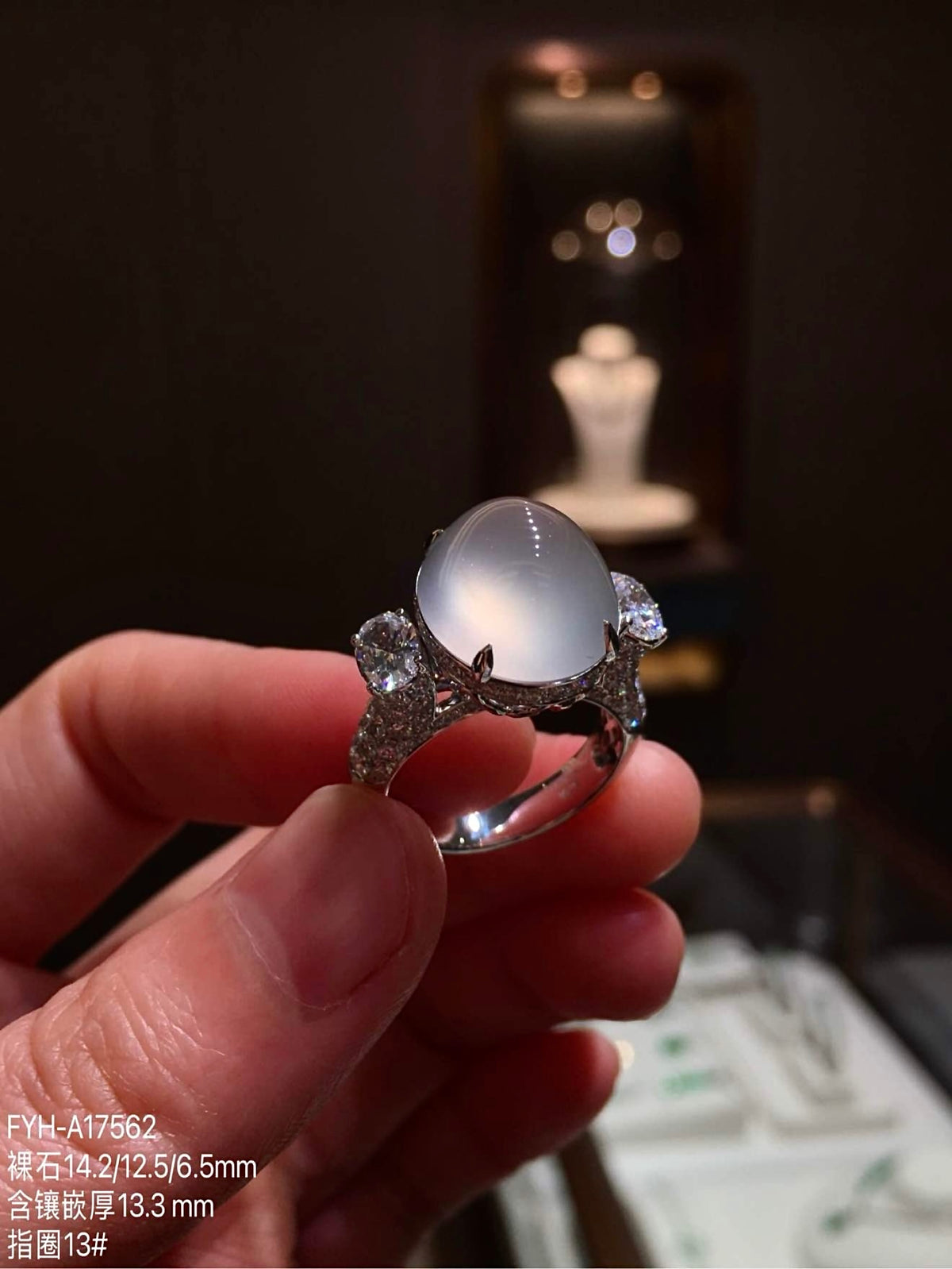 Three-quarter view of the high-icy jadeite ring and its diamond-accented 18K gold setting