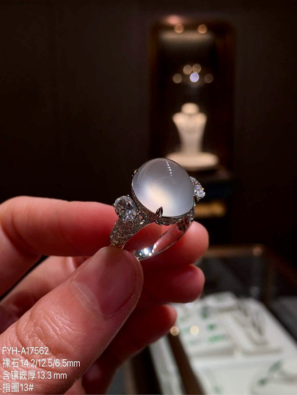 Angled front view highlighting the jadeite cabochon dome and diamond-set shoulders