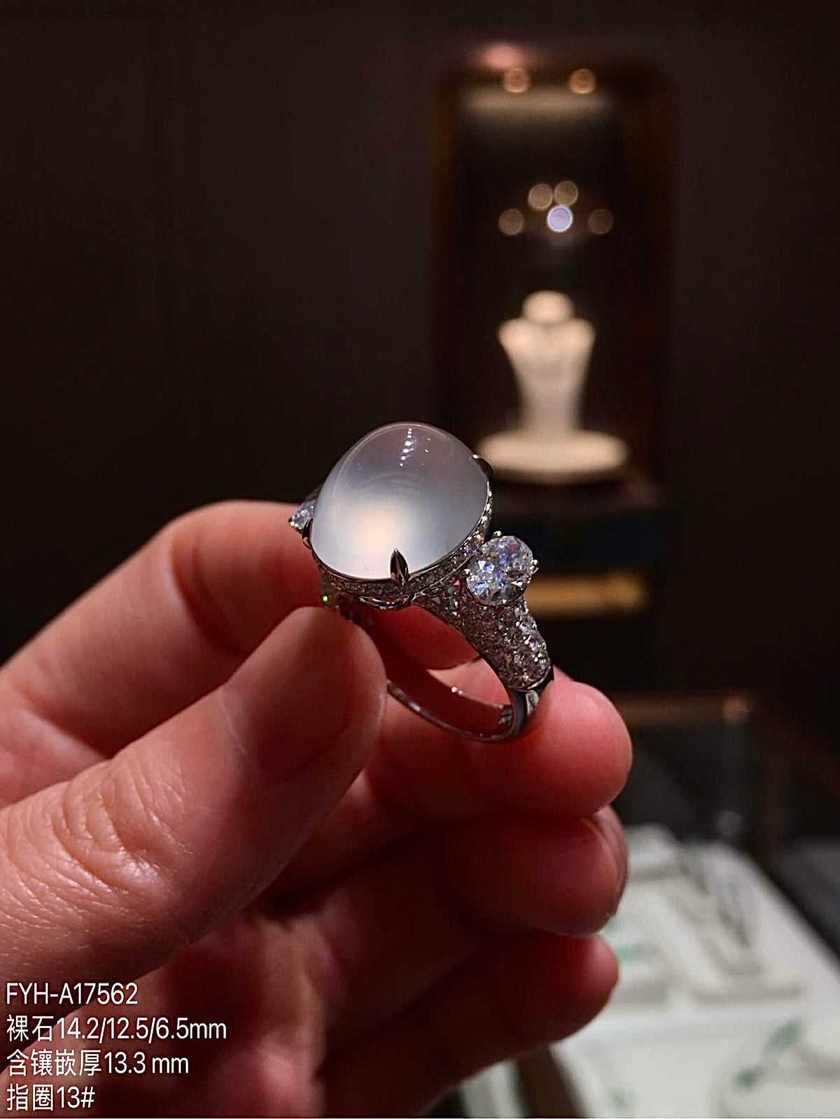 Side profile of the high-icy jadeite cabochon ring with diamond-set 18K gold band