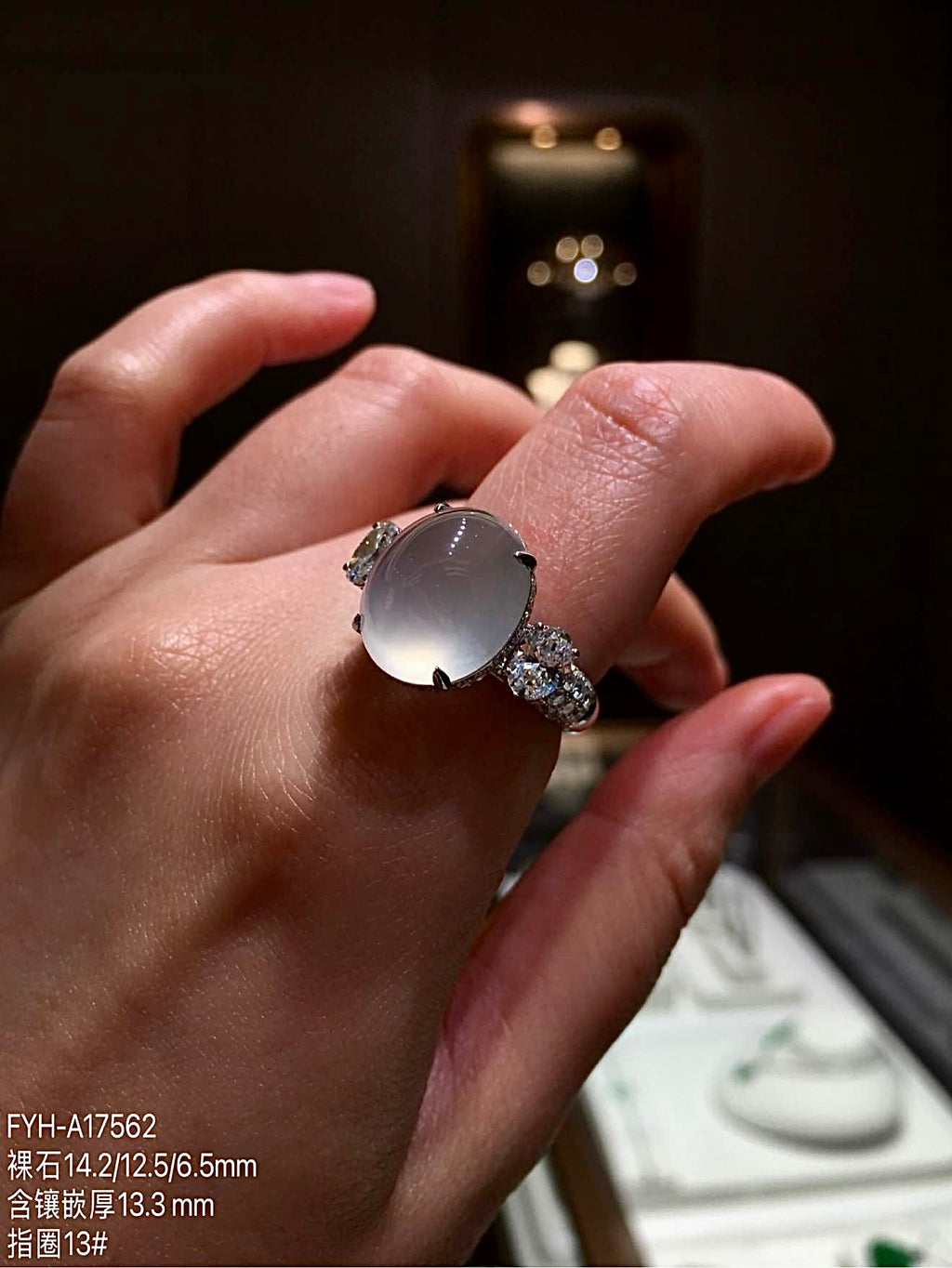 High-icy jadeite cabochon ring worn on a hand, showing its oval proportions