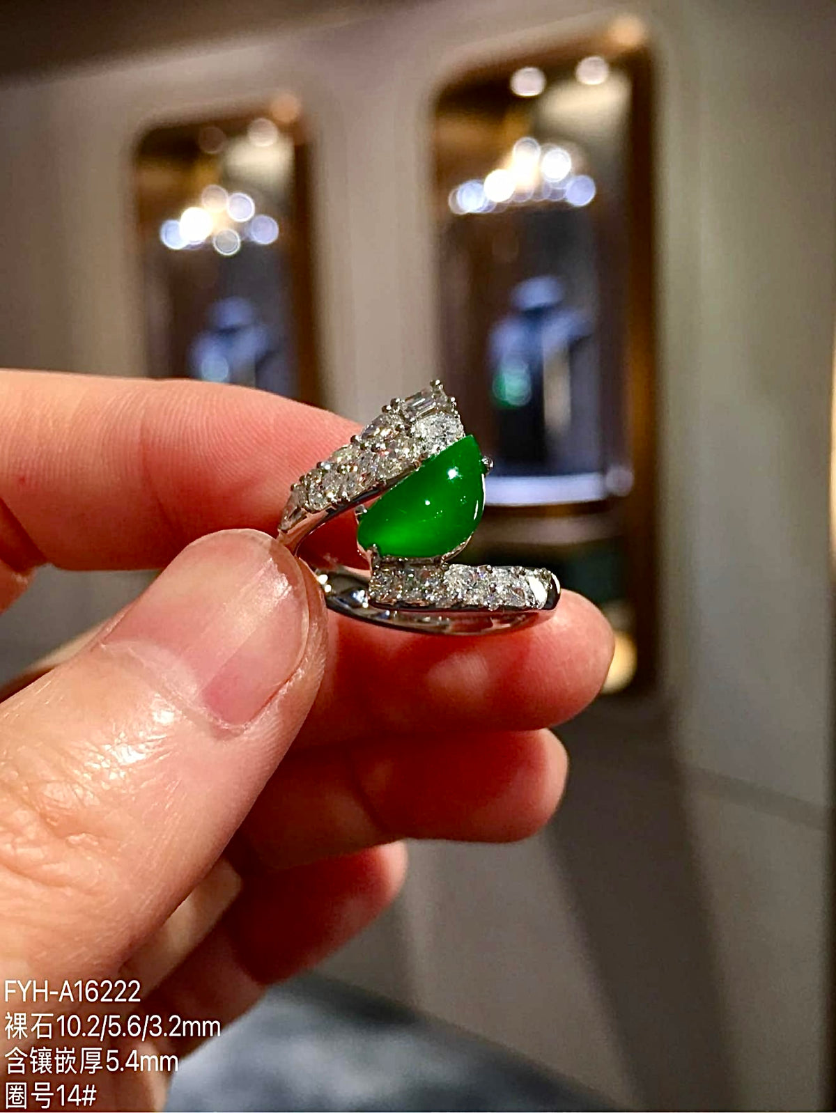 Side view of pear-shaped green jadeite ring in 18K gold with diamonds