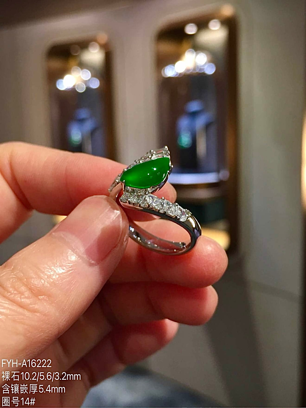 Profile view of green jadeite ring showing the diamond-set 18K gold band