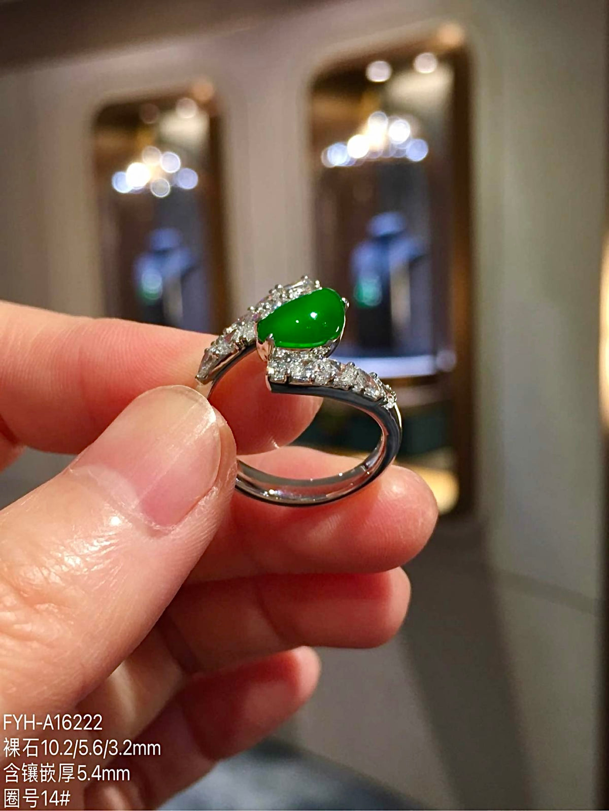 Front view of pear-shaped green jadeite and open diamond-set ring design