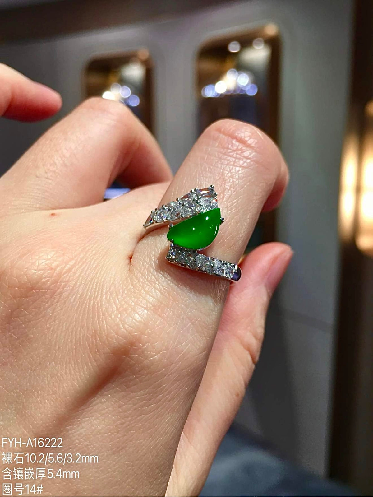 Green jadeite and diamond ring worn on the hand