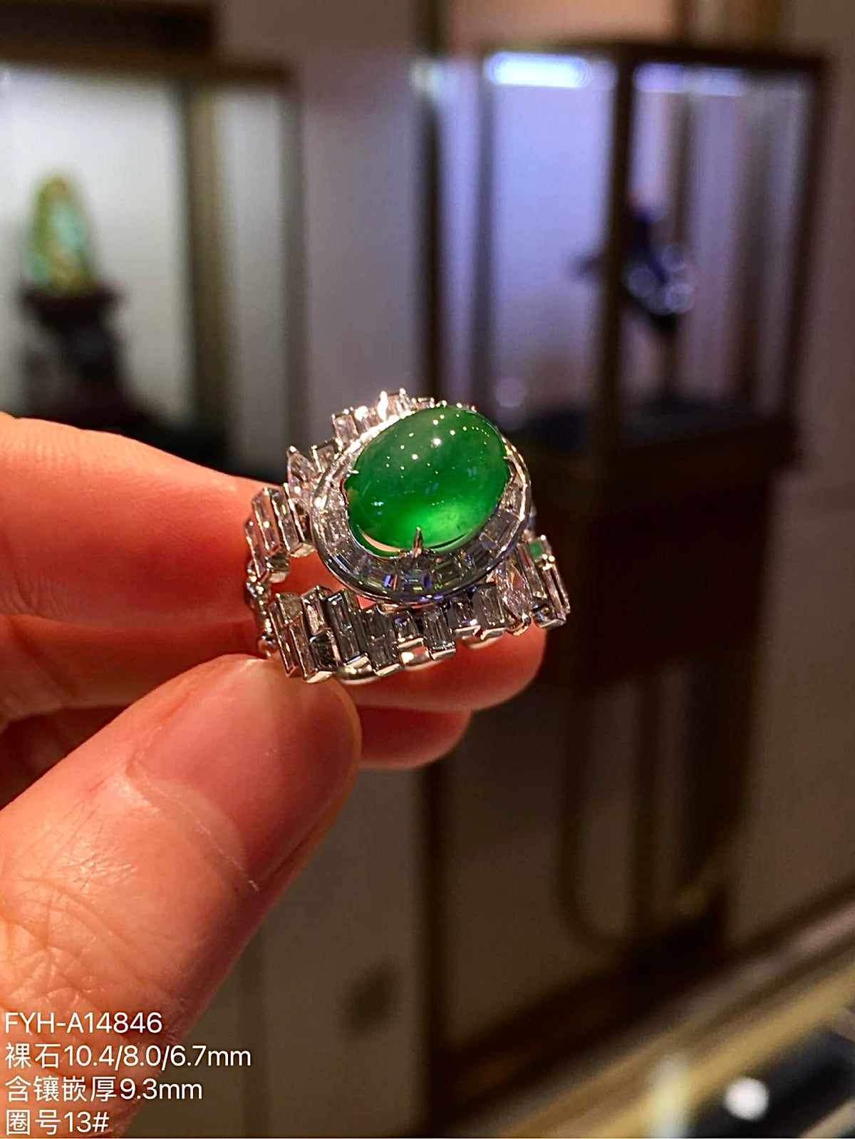 Natural Myanmar yang green jadeite cabochon ring with diamond-set shoulders, close angled view