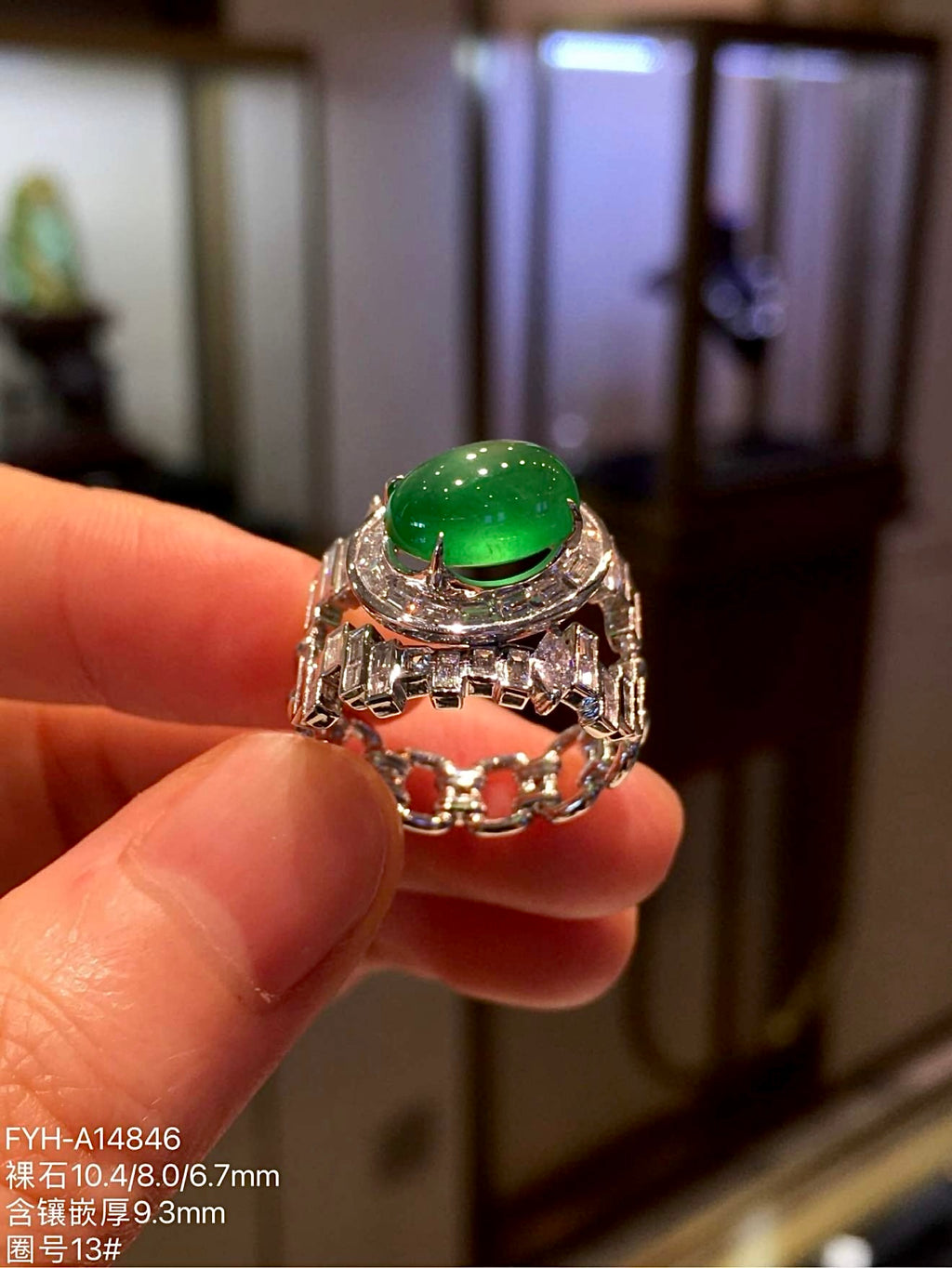 Side profile of the jadeite cabochon ring showing its raised setting and diamond-set band