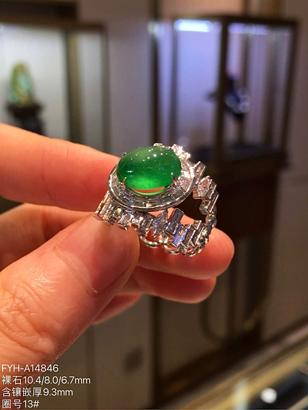 Yang green jadeite cabochon ring with diamond-set shoulders, angled view
