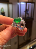 Yang green jadeite cabochon ring with diamond-set shoulders, angled view