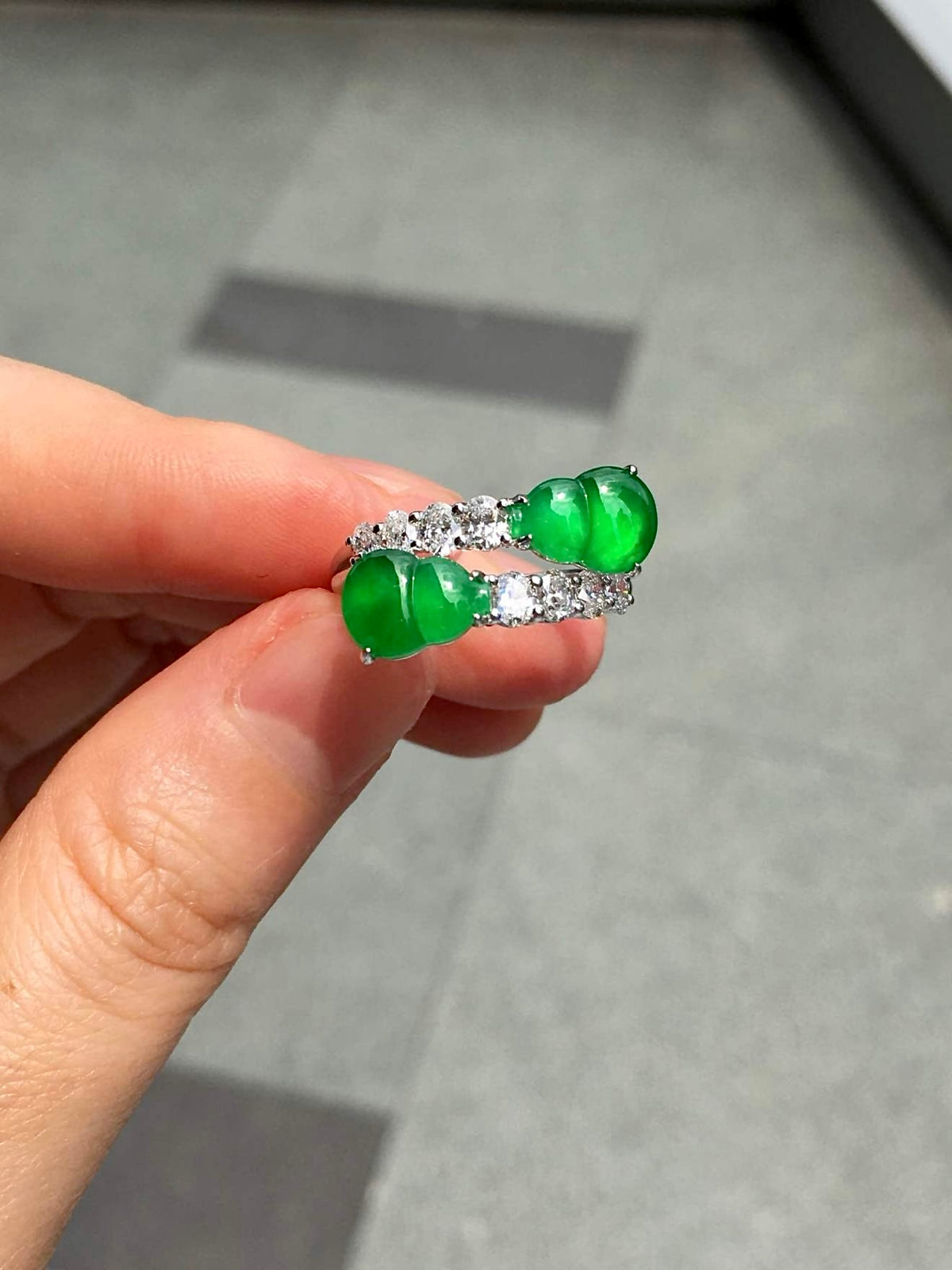 Paired jadeite gourd ring with diamonds photographed against a neutral background