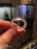 Front view of glass-type jadeite band ring held between fingers