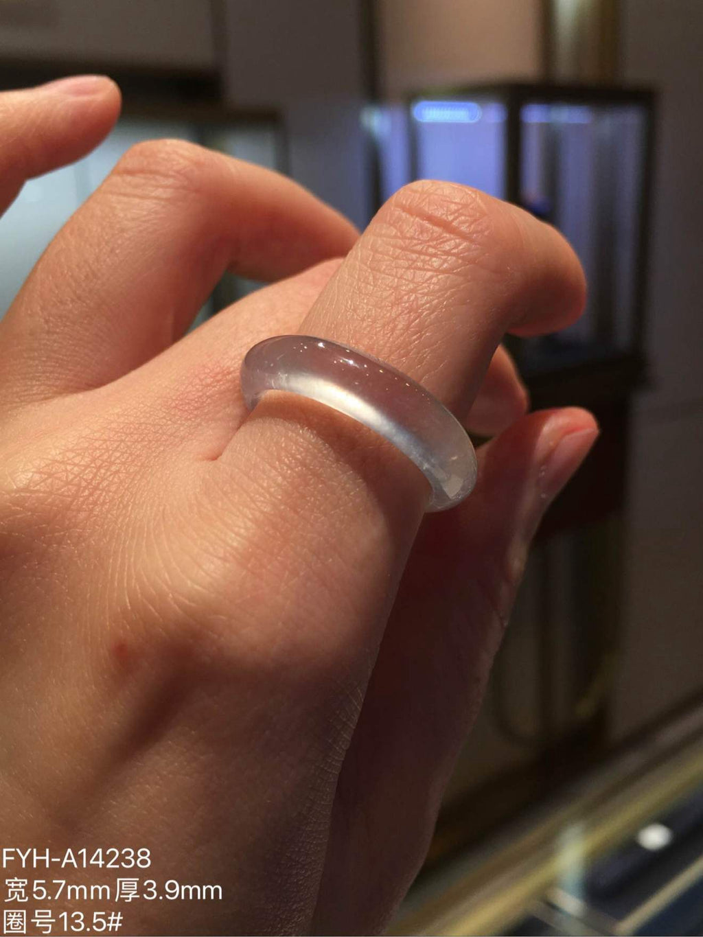 Glass-type jadeite band ring worn on a finger to show scale