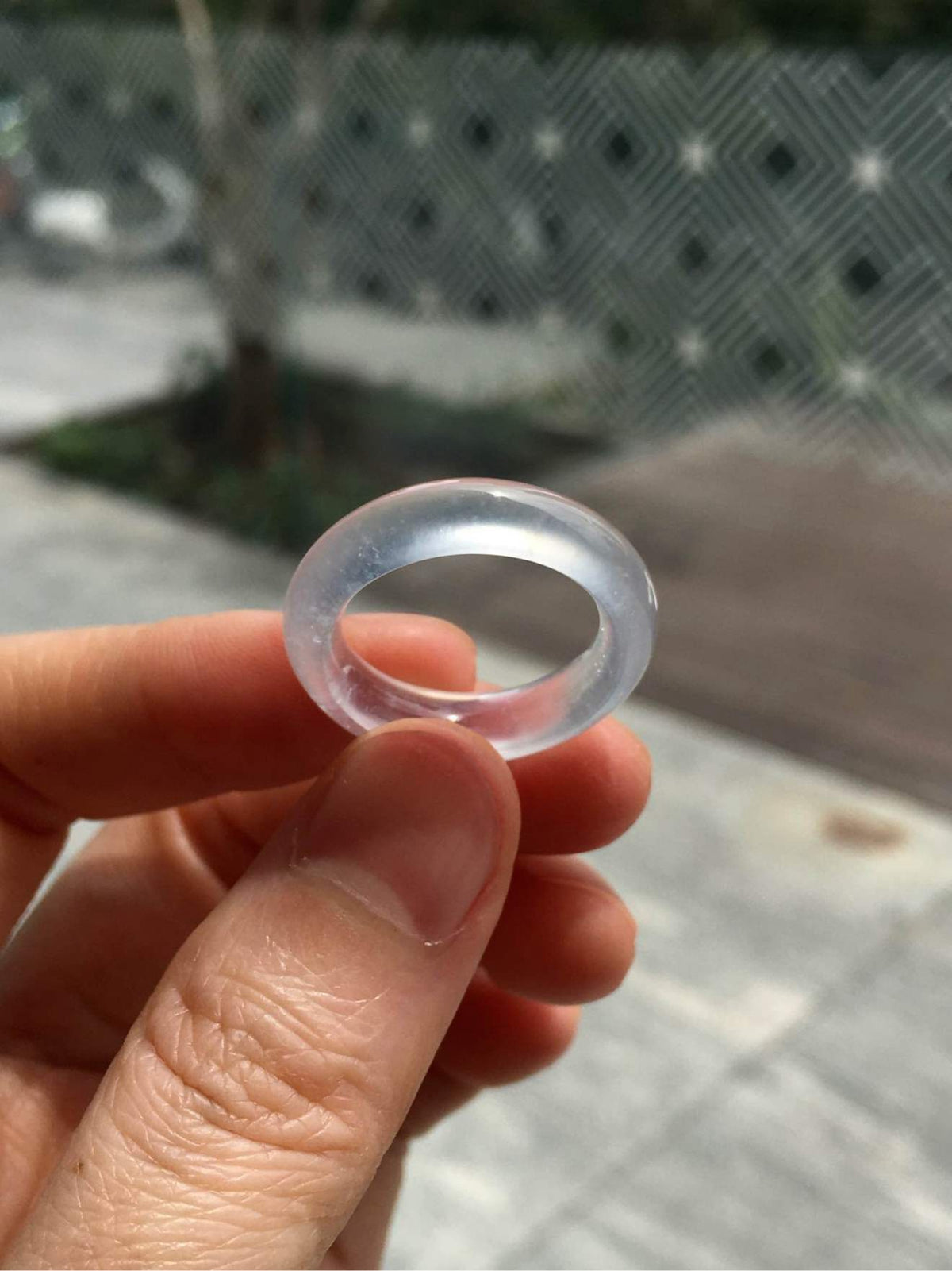 Unmounted glass-type jadeite band ring shown against a neutral background