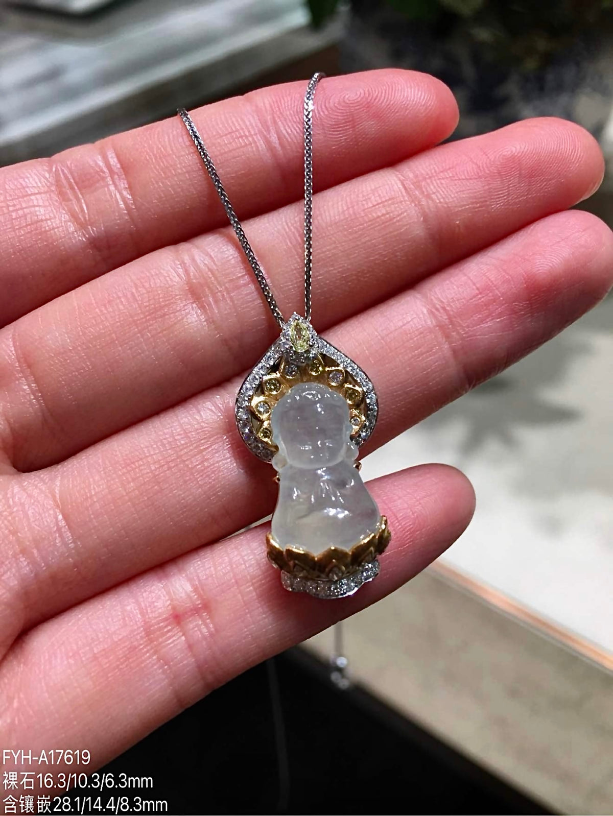 Front close view of carved jadeite Baby Buddha pendant with diamond setting