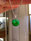 Front view of jadeite Ping An Kou with broad floating green colour on its chain