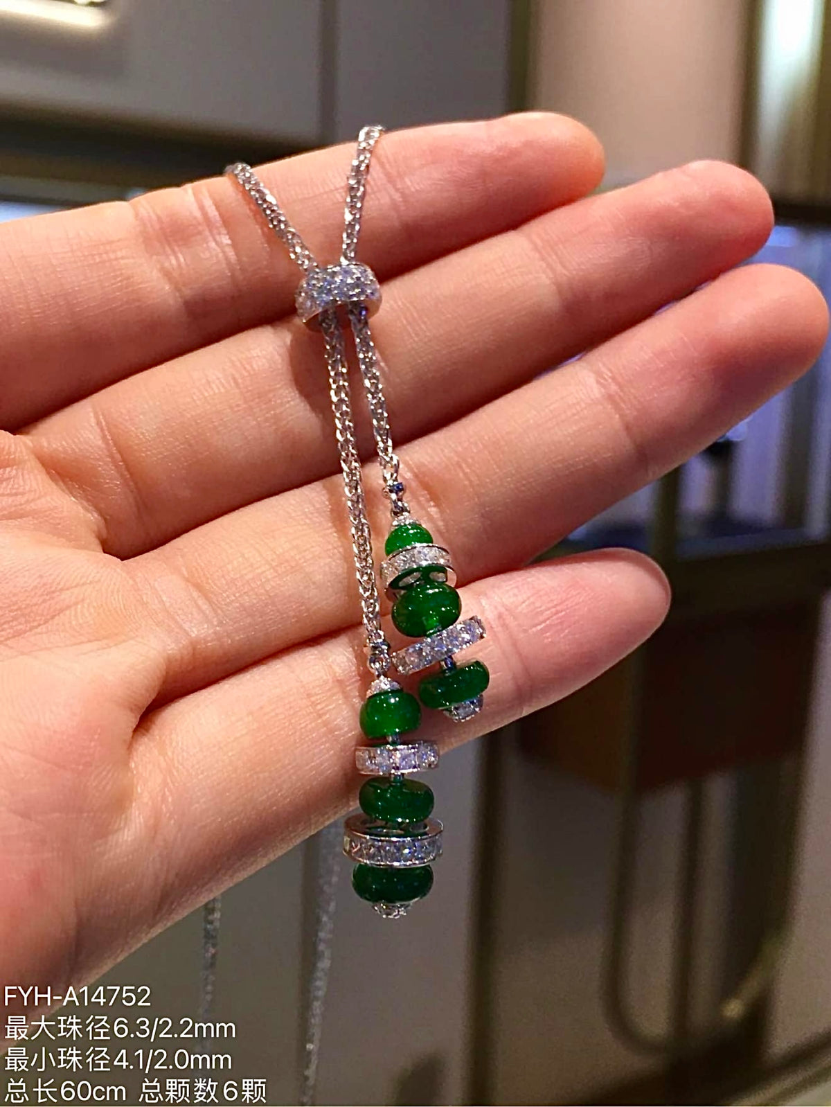 Close view of green jadeite Lu Lu Tong beads and diamond-set accents