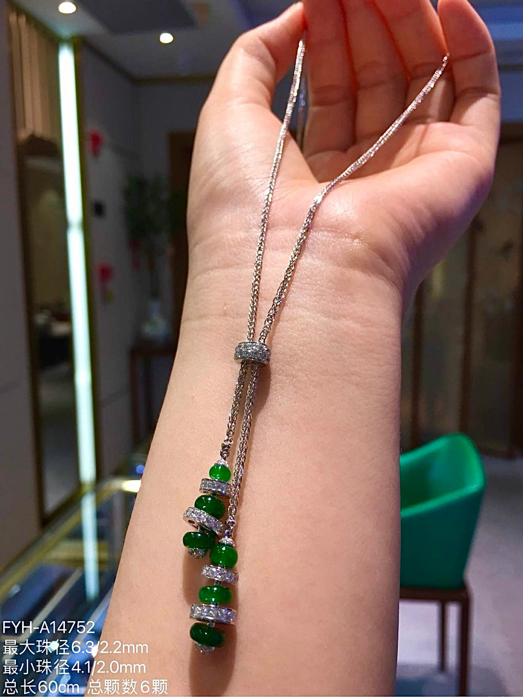 Full 60 cm Lu Lu Tong jadeite necklace draped over a hand