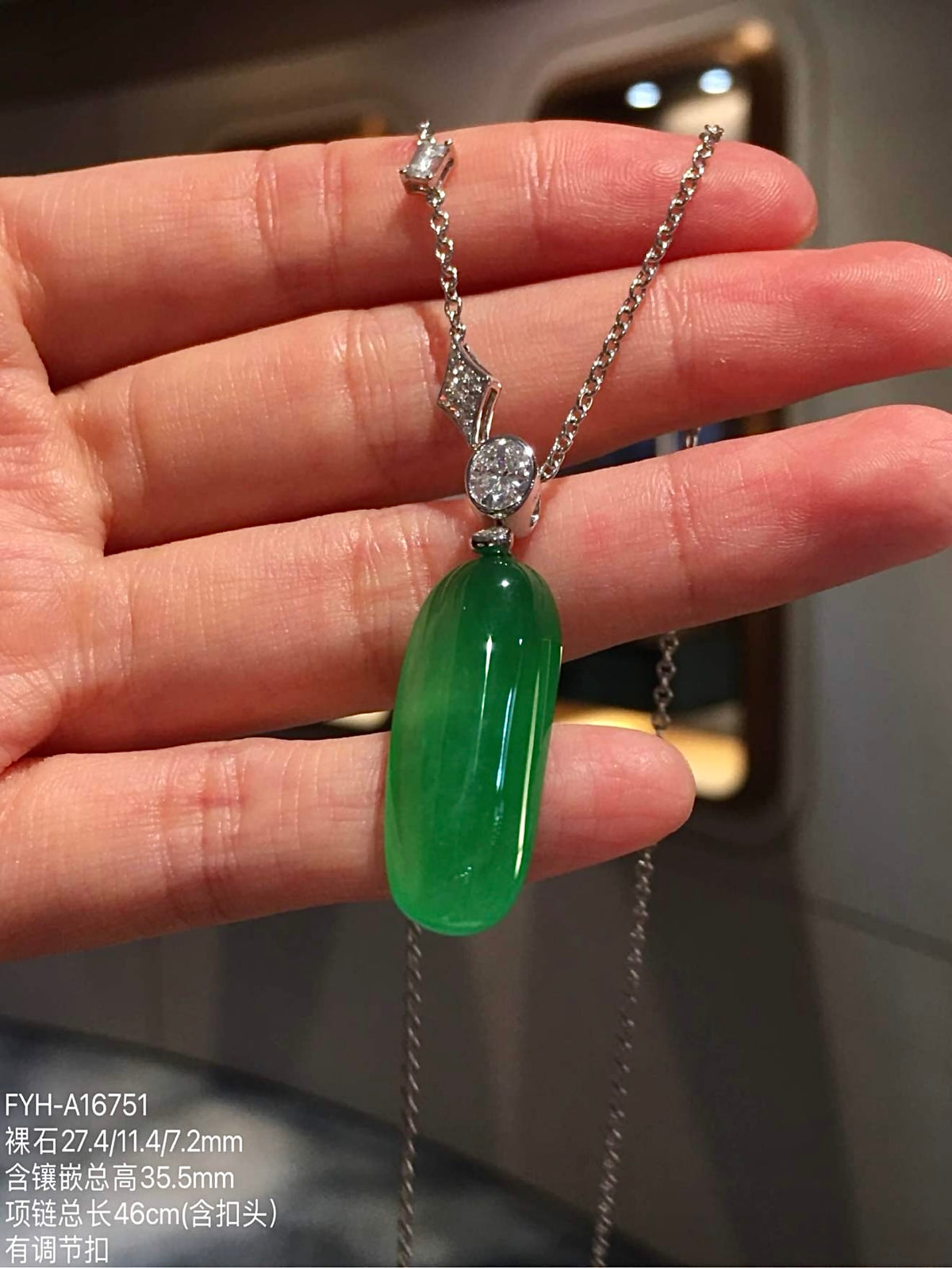 Angled front view of jadeite Fu Gua necklace with diamond-set chain detail