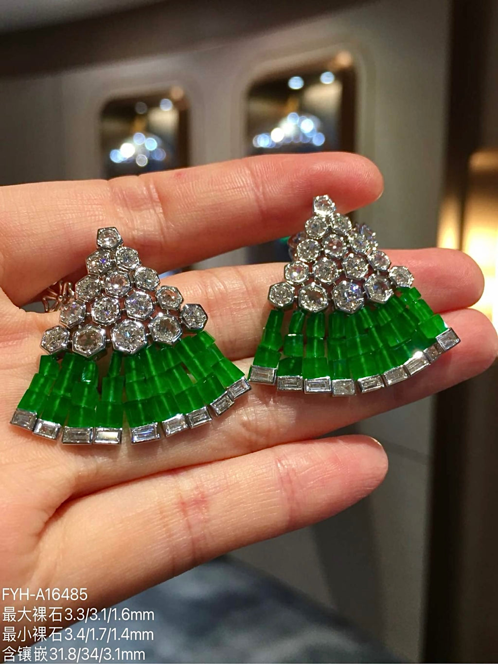 Angled view of the layered imperial-green jadeite fan and geometric diamond settings