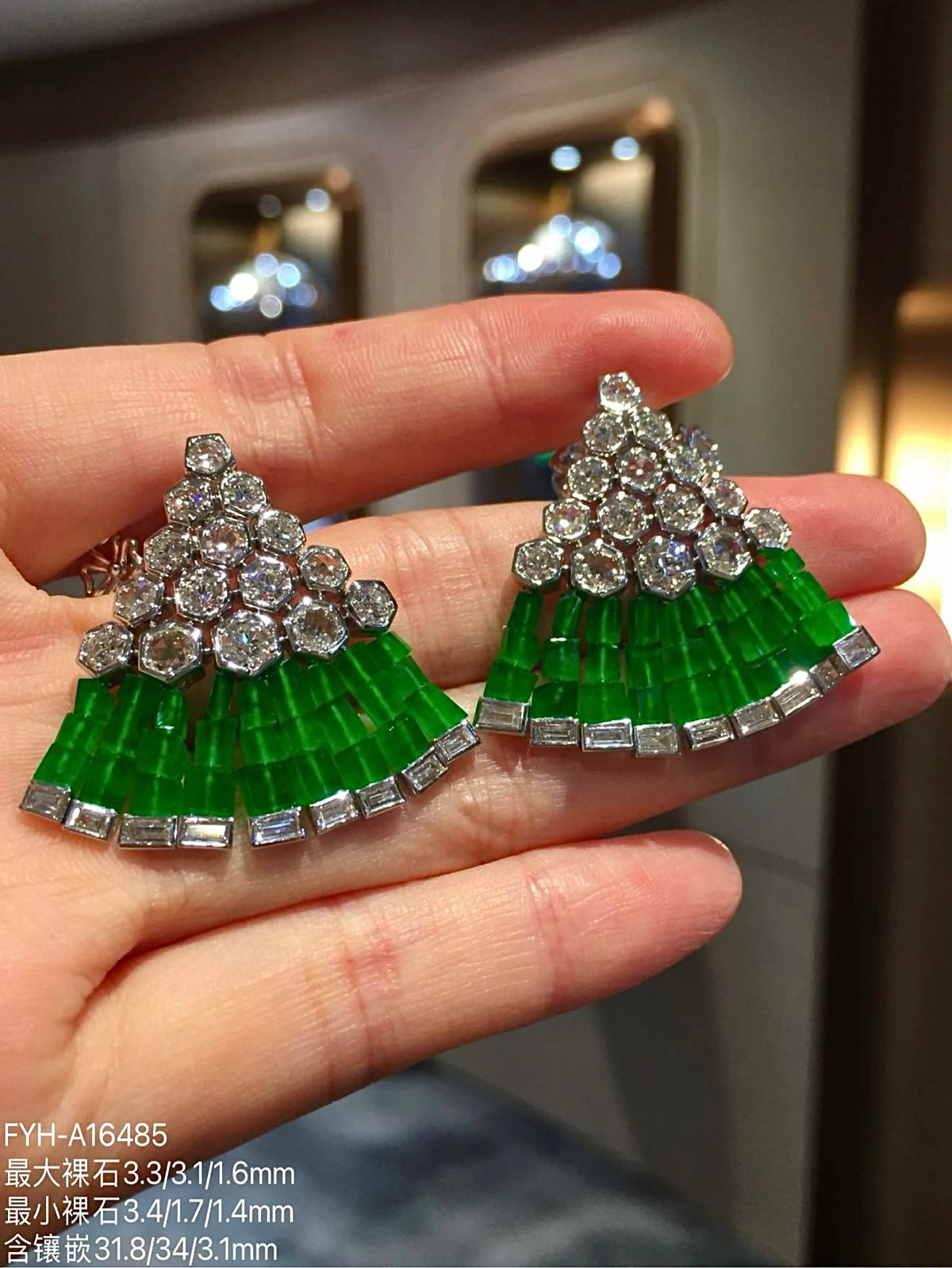 Angled view of the layered imperial-green jadeite fan and geometric diamond settings