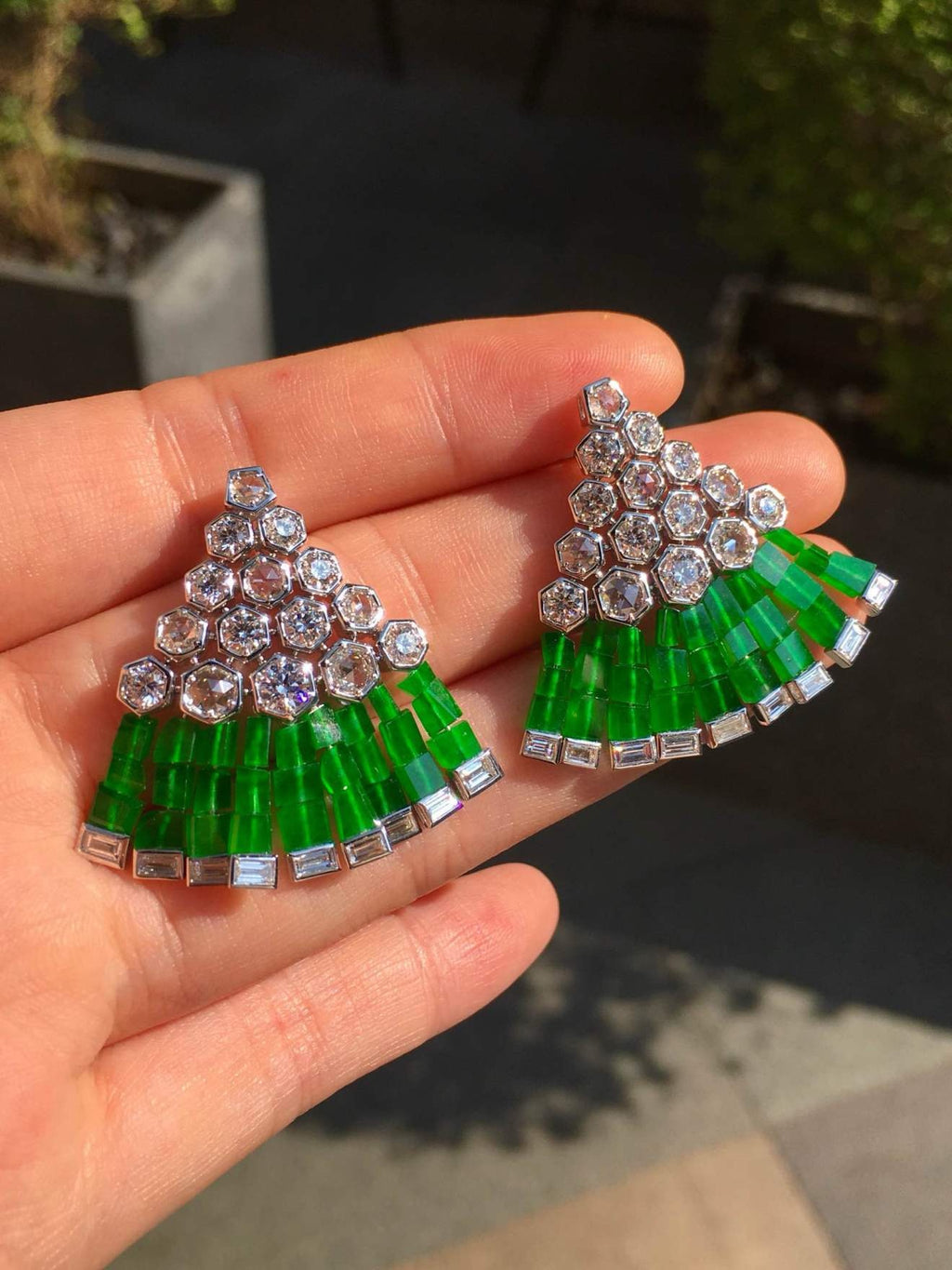 Outdoor view of the green jadeite and diamond earrings in natural light