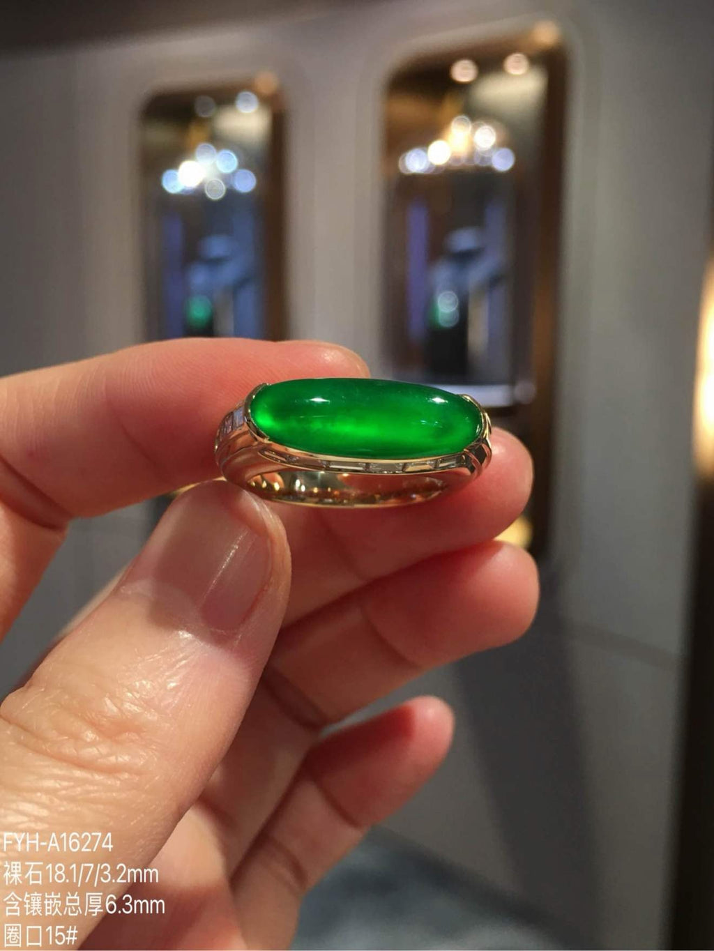 Front view of glass-type imperial green jadeite bar ring in 18K gold and diamonds