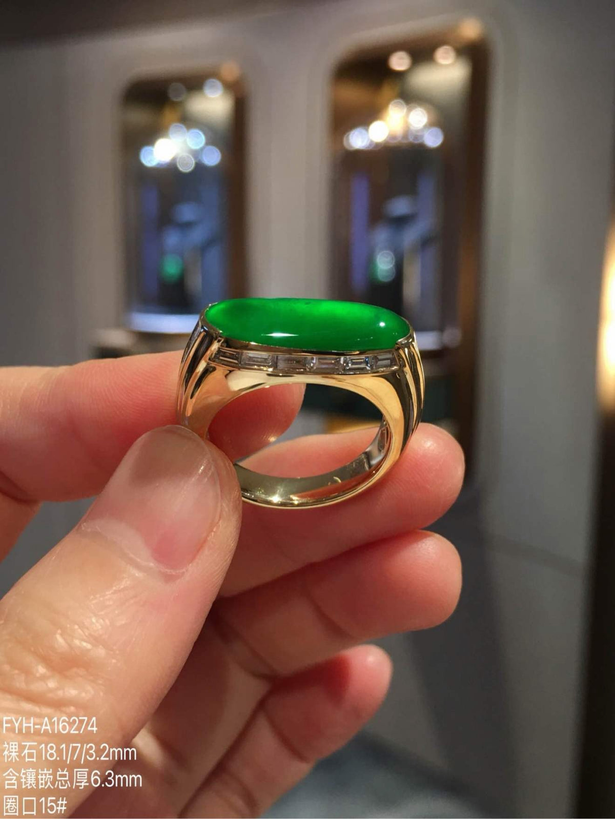 Side profile showing the elongated imperial green jadeite cabochon and diamond-set 18K gold band