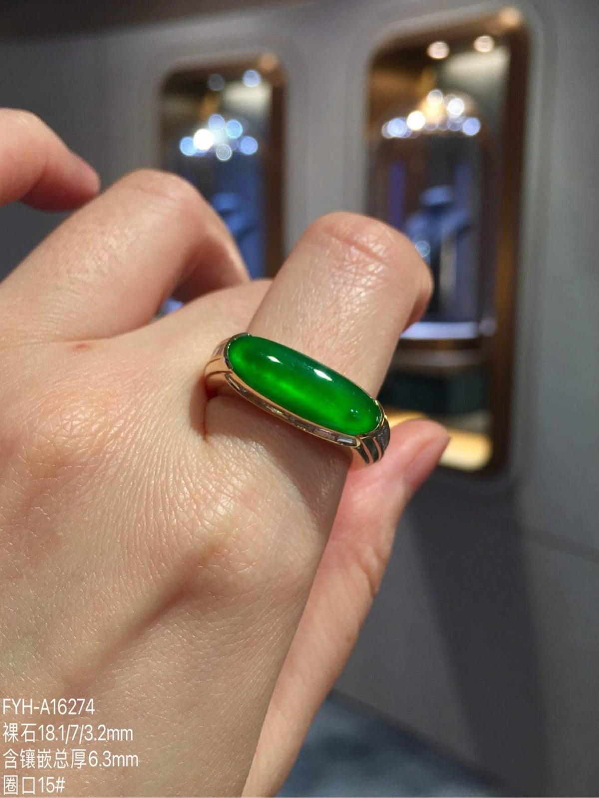 On-hand view of the imperial green jadeite ring showing its elongated profile
