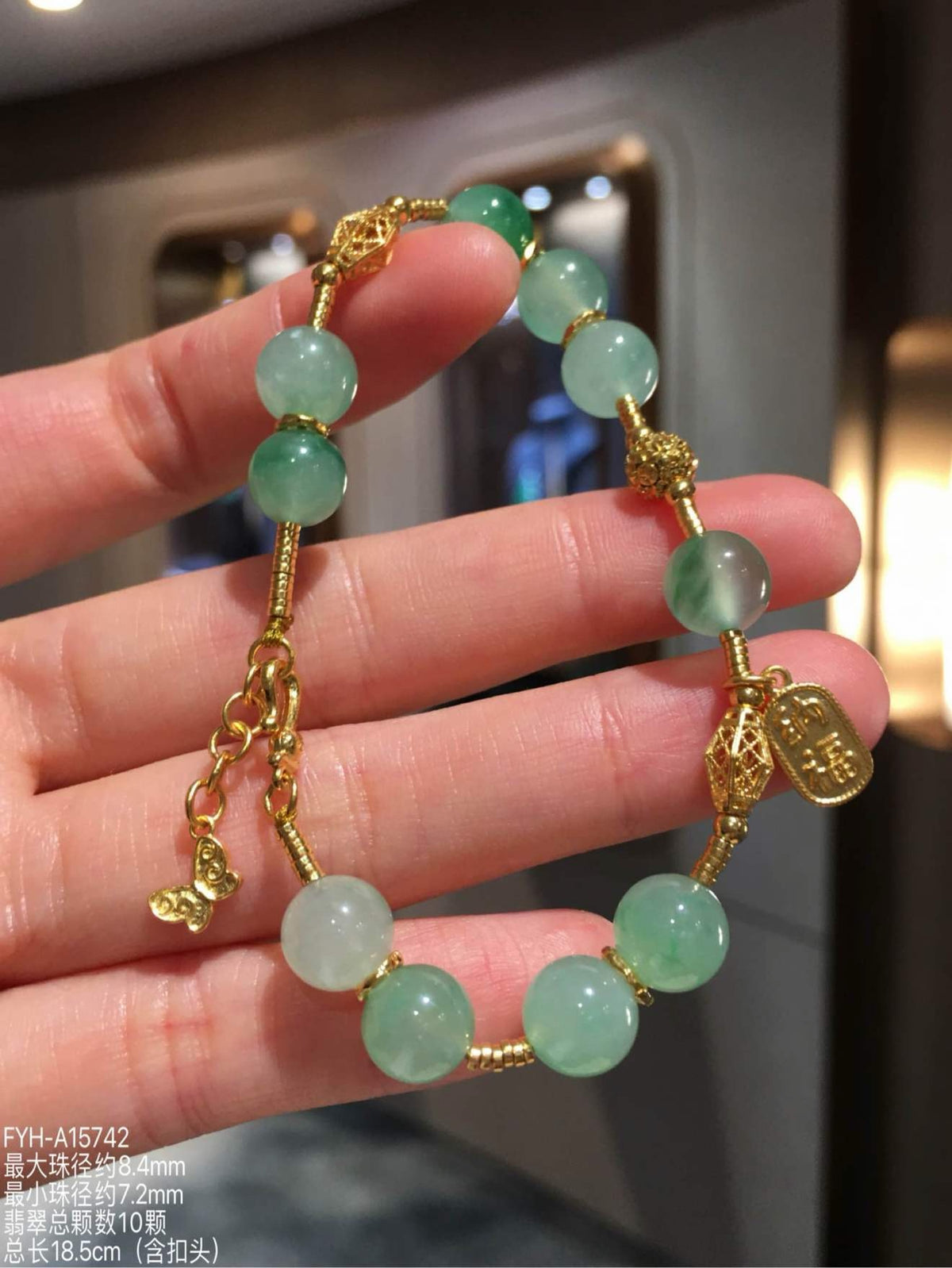 Front view of FYH-A15742, an icy vivid green jadeite bead bracelet with 24K gold